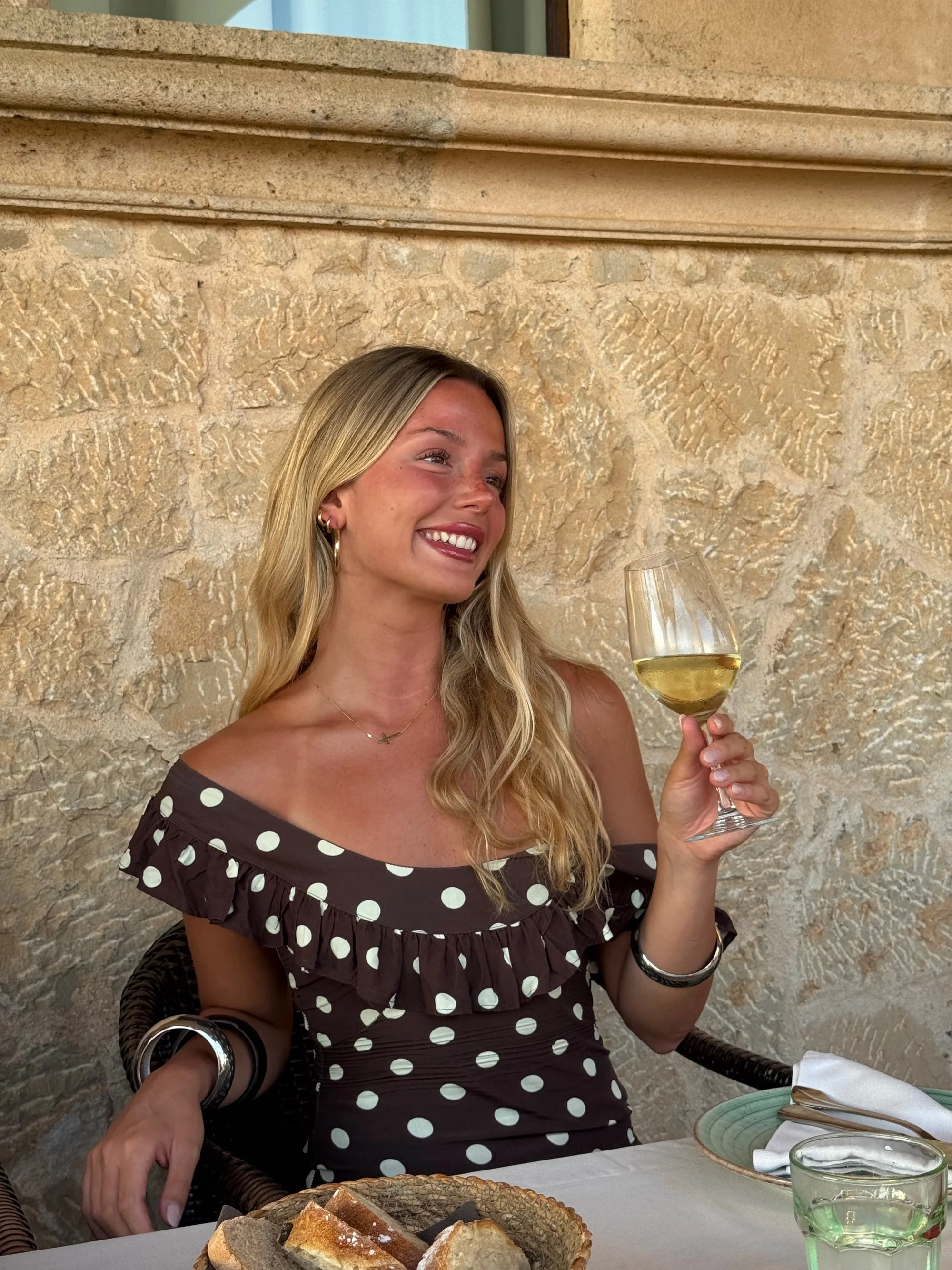 Model wearing the brown and cream polka dot dress at an event
